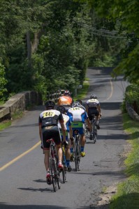 group of cyclists on 2 lane road